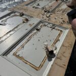 Historic paint being stripped from the Craigmyle door panels