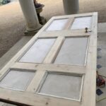Craigmyle door leaf stripped back to bare timber on trestles