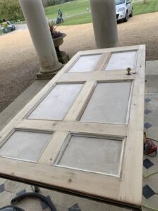 Craigmyle door leaf stripped back to bare timber on trestles