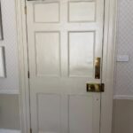 Craigmyle door rehung in situ with overhead closer and brass furniture