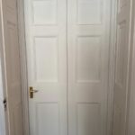 New library door-set seen from the adjoining side, sitting among matching panelled doors